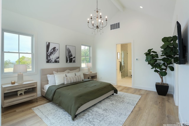 bedroom featuring connected bathroom, light hardwood / wood-style flooring, beamed ceiling, and an inviting chandelier