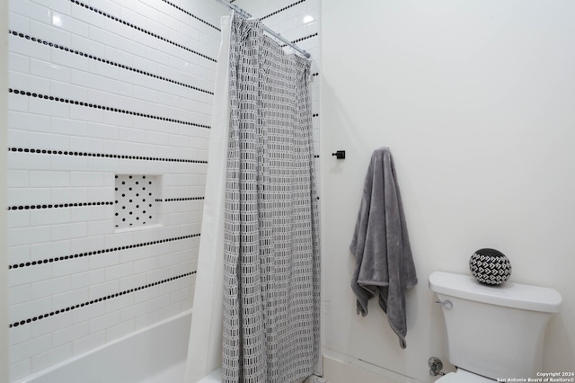 bathroom with shower / bath combo and toilet