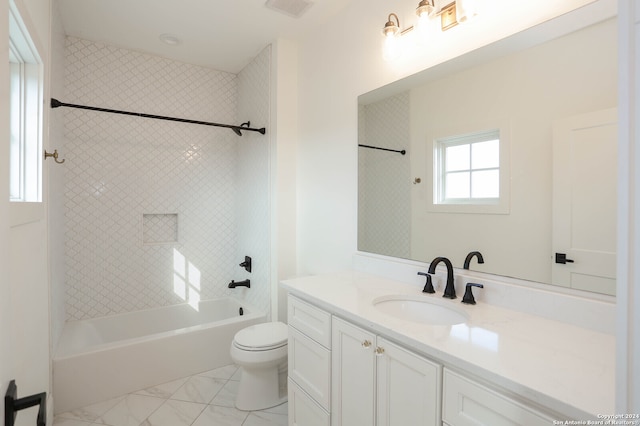 full bathroom with vanity, toilet, and tiled shower / bath