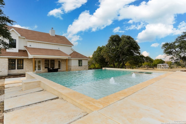 view of swimming pool with a patio area and pool water feature