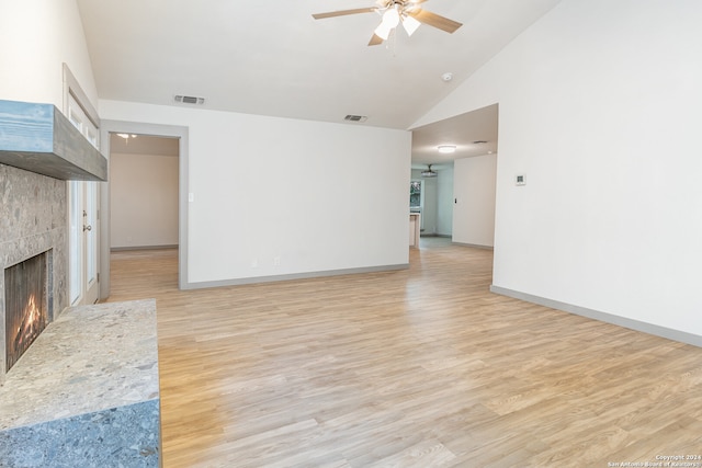 unfurnished living room featuring ceiling fan, a fireplace, high vaulted ceiling, and light hardwood / wood-style floors