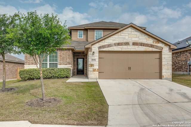 view of front of home featuring a front lawn and a garage