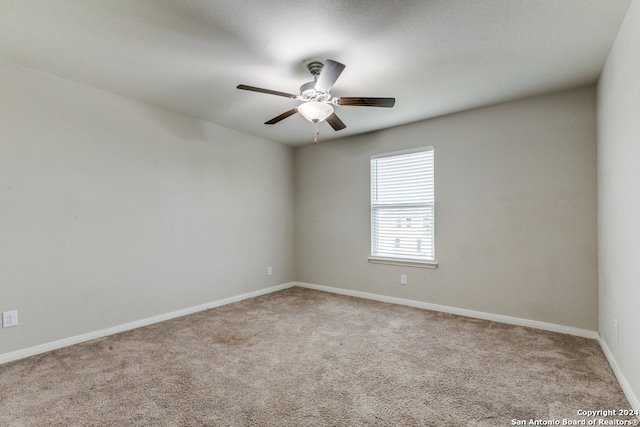 unfurnished room featuring light carpet and ceiling fan