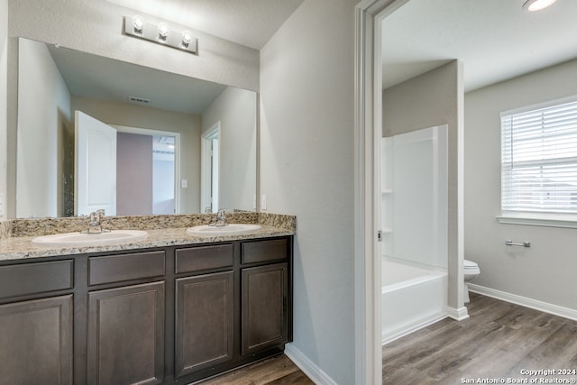 bathroom with vanity, wood-type flooring, and toilet