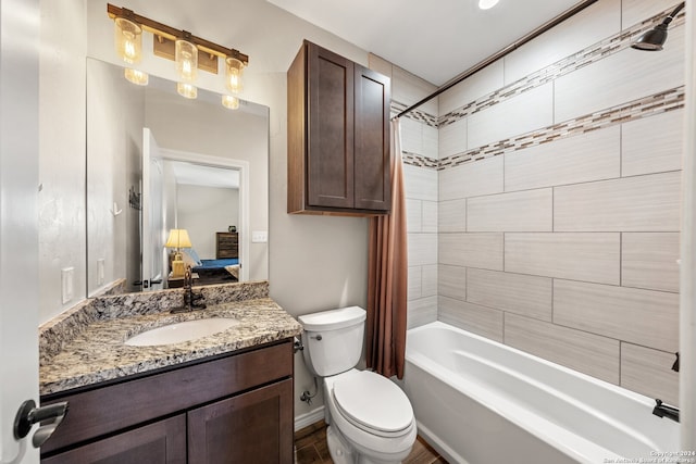 full bathroom featuring shower / bath combination with curtain, toilet, and vanity