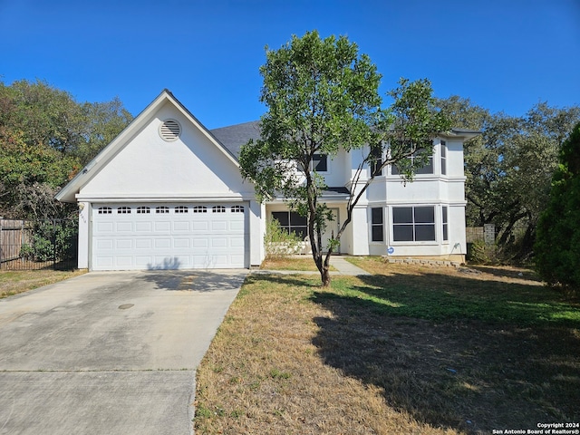 view of front facade with a front yard and a garage