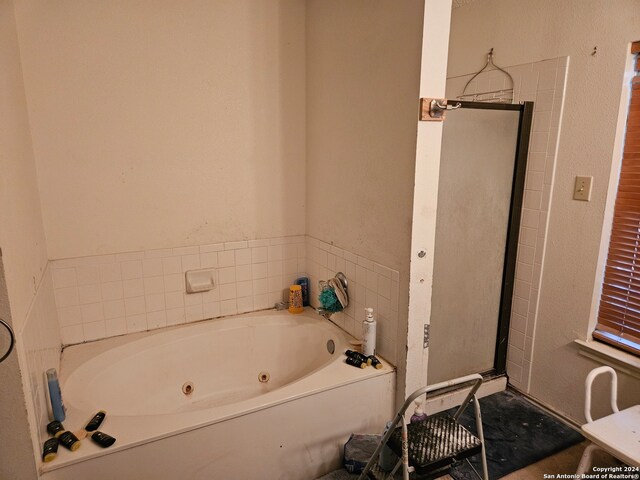 bathroom with separate shower and tub