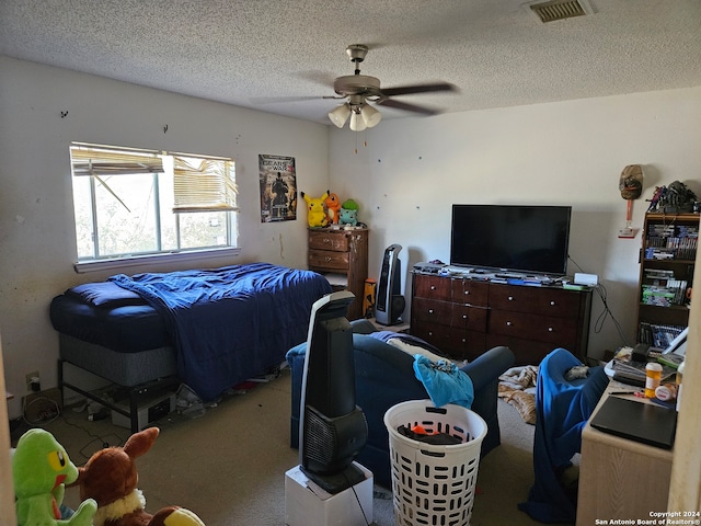 bedroom with ceiling fan and a textured ceiling