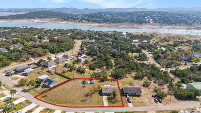 birds eye view of property with a water and mountain view