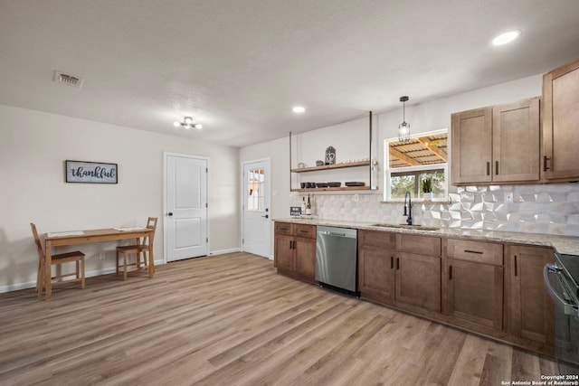 kitchen with decorative backsplash, light wood-type flooring, stainless steel dishwasher, sink, and pendant lighting