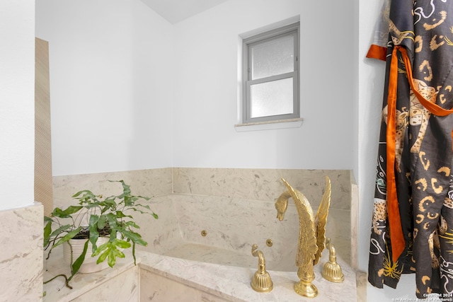 bathroom featuring tiled tub