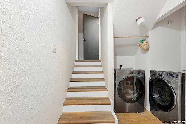 washroom with washer and dryer and wood-type flooring