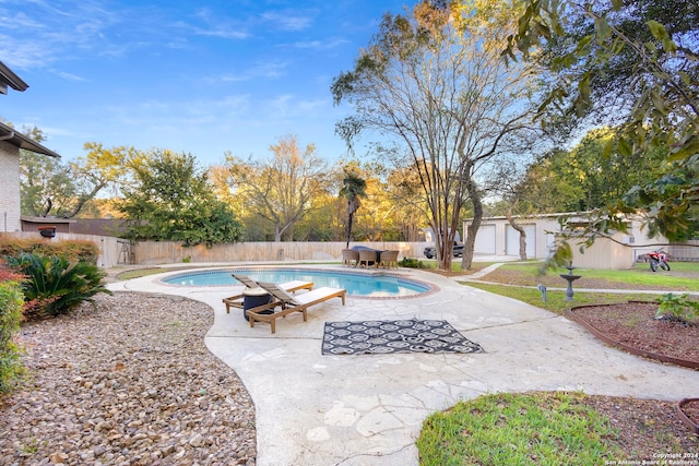 view of pool featuring an outbuilding and a patio