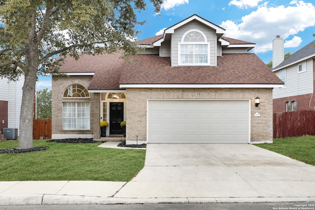 front of property with central AC unit, a garage, and a front lawn