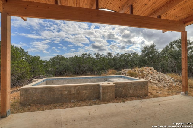 1722 Paradise Pkwy, Canyon Lake, TX 78133 - view of swimming pool with an empty pool and view of wooded area