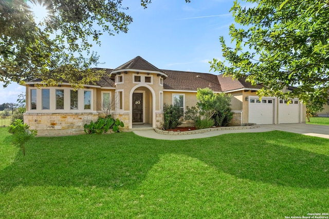 view of front of house with a garage and a front lawn