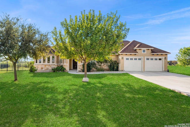 obstructed view of property featuring a garage and a front lawn