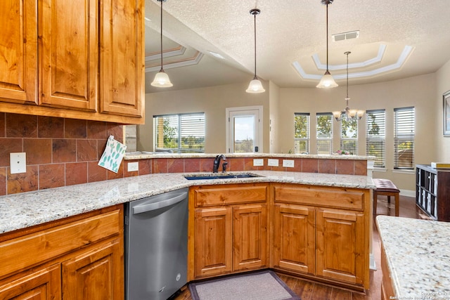 kitchen with a raised ceiling, sink, stainless steel dishwasher, a textured ceiling, and dark hardwood / wood-style flooring