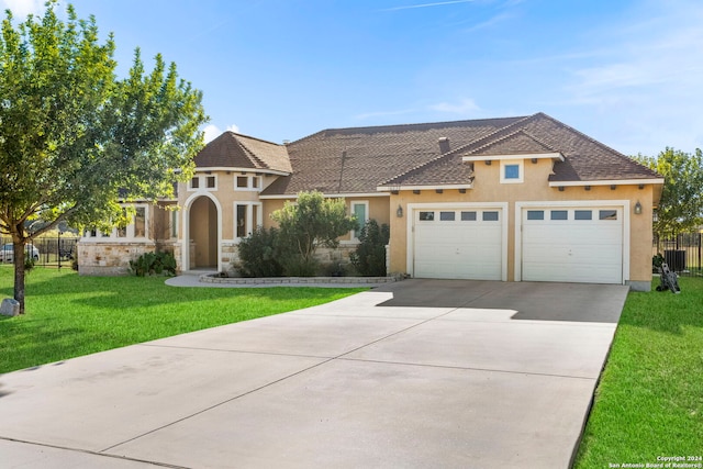 view of front facade with a garage and a front lawn