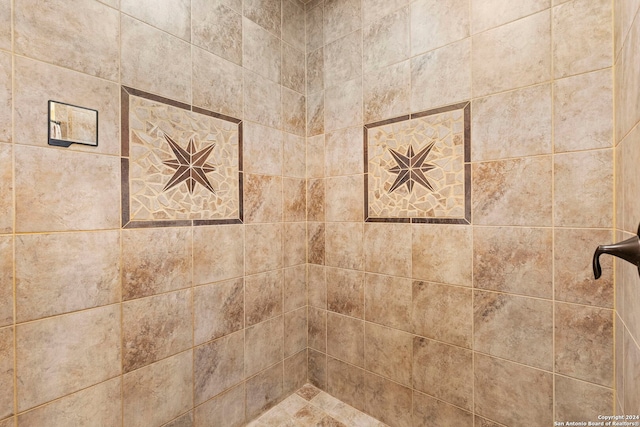 bathroom with tiled shower