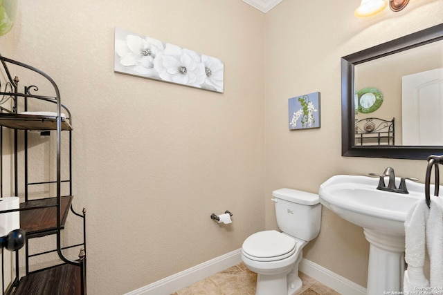 bathroom featuring tile patterned flooring, toilet, and ornamental molding