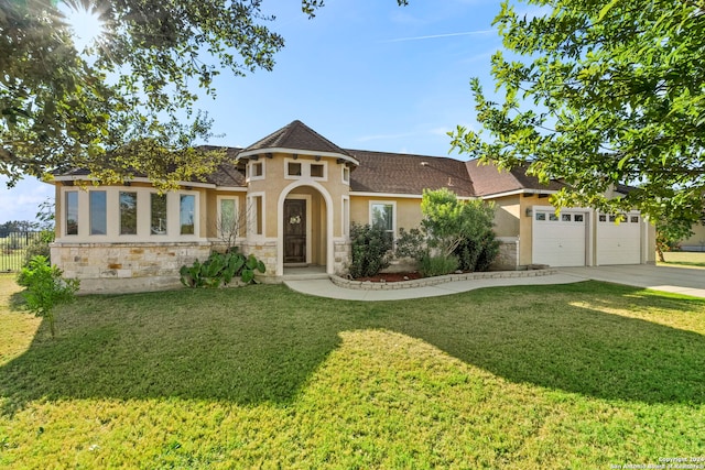 view of front facade with a front yard and a garage