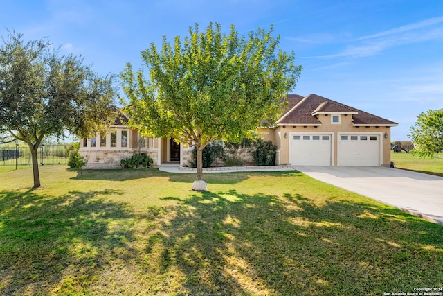 obstructed view of property with a garage and a front yard