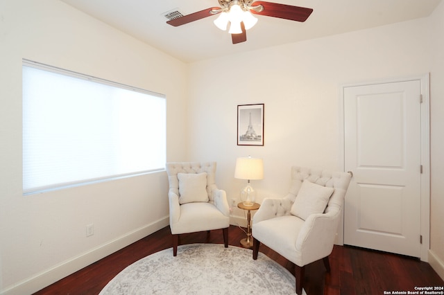 living area with dark hardwood / wood-style flooring and ceiling fan