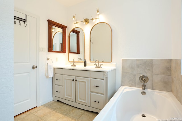 bathroom featuring a washtub, vanity, and tile patterned floors