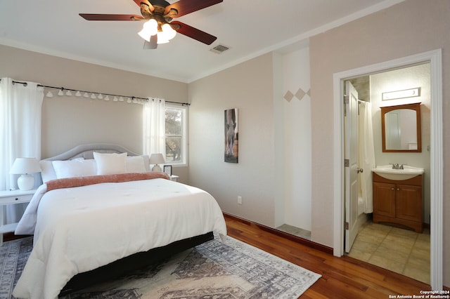 bedroom with ensuite bathroom, ceiling fan, crown molding, sink, and hardwood / wood-style flooring