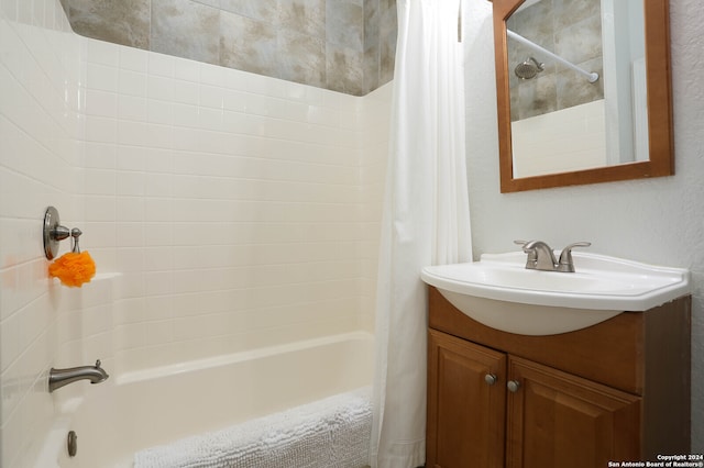 bathroom featuring vanity and shower / tub combo with curtain