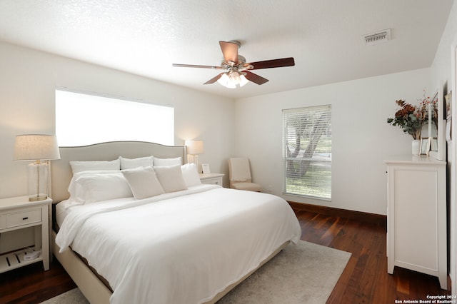 bedroom featuring ceiling fan and dark hardwood / wood-style floors