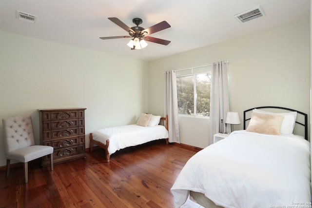 bedroom with ceiling fan and dark wood-type flooring