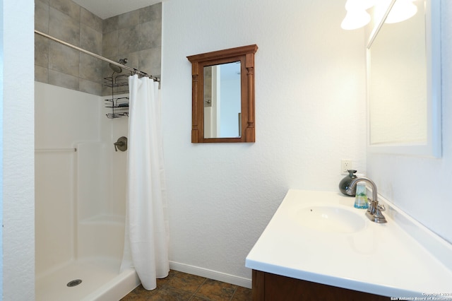 bathroom featuring vanity and curtained shower