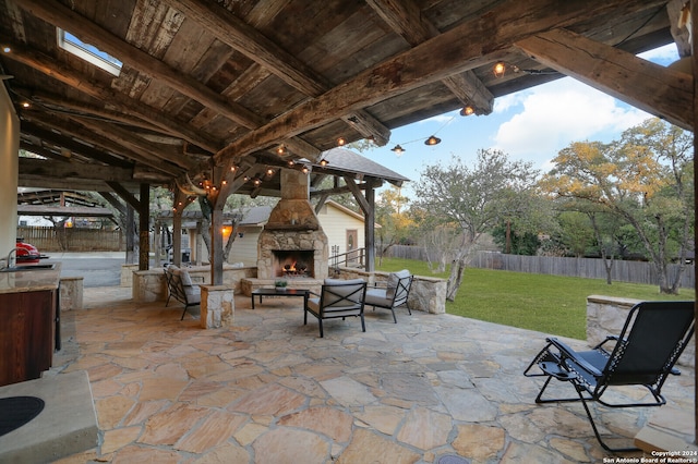 view of patio featuring a gazebo, an outdoor living space with a fireplace, and sink