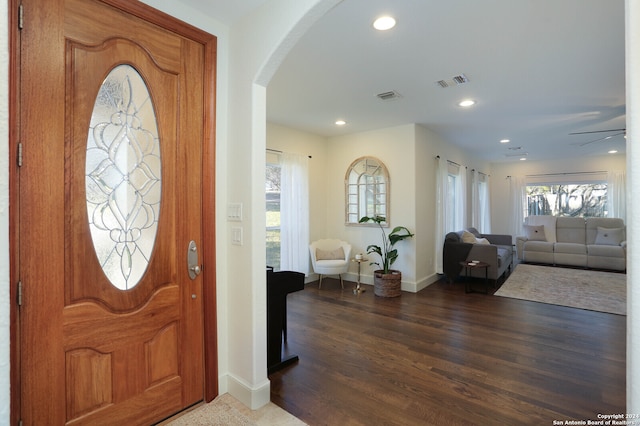 foyer entrance featuring ceiling fan and dark wood-type flooring