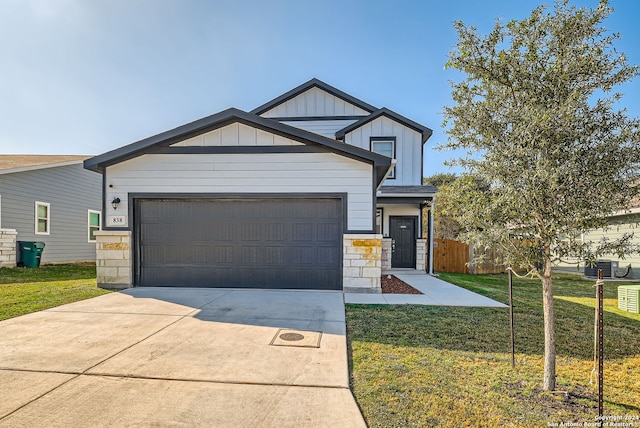 view of front of house with a garage and a front lawn