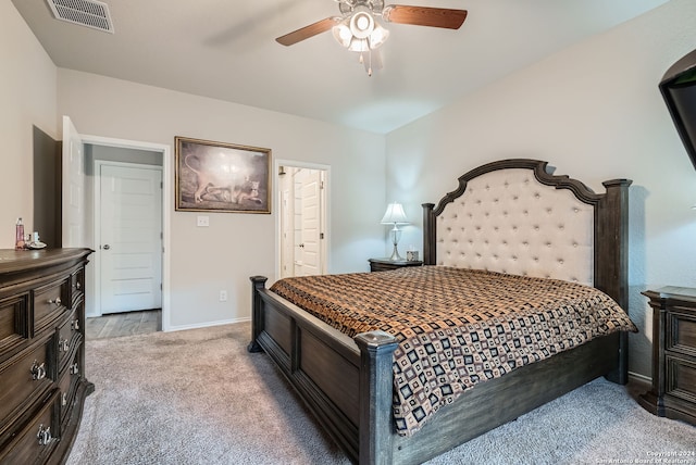 carpeted bedroom featuring ensuite bathroom and ceiling fan