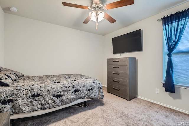 bedroom with ceiling fan and light carpet