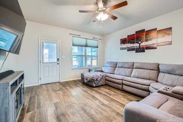 living room with ceiling fan and wood-type flooring