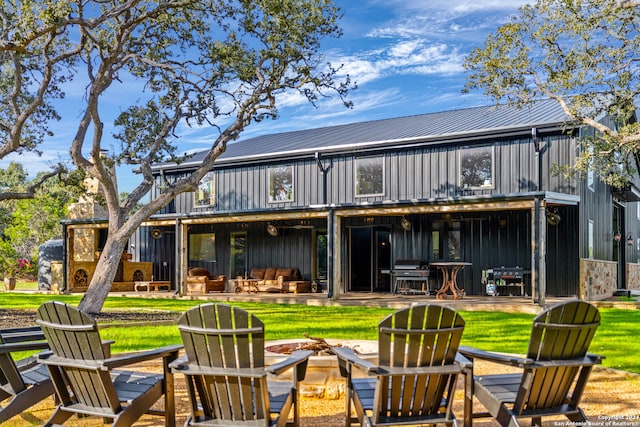 rear view of house featuring an outdoor fire pit