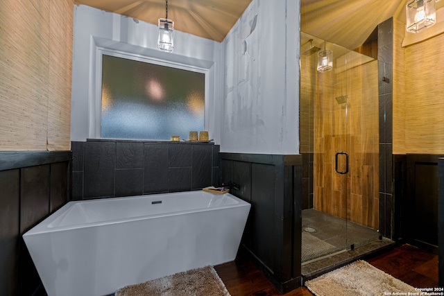 bathroom featuring hardwood / wood-style floors, lofted ceiling, and shower with separate bathtub