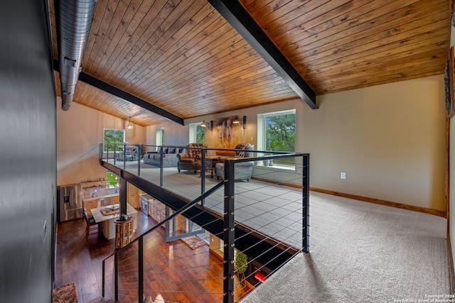 interior space with vaulted ceiling with beams, dark hardwood / wood-style flooring, and wooden ceiling