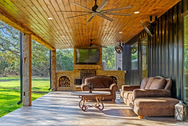 view of patio / terrace featuring an outdoor stone fireplace and ceiling fan