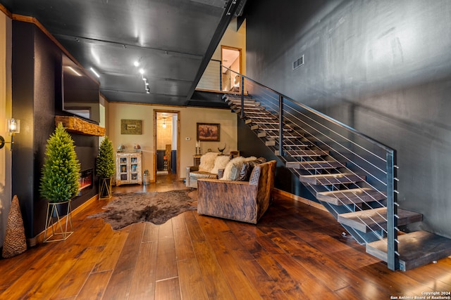 living room with track lighting and hardwood / wood-style flooring