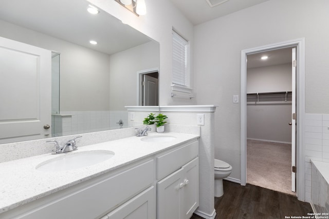 bathroom featuring hardwood / wood-style flooring, vanity, and toilet