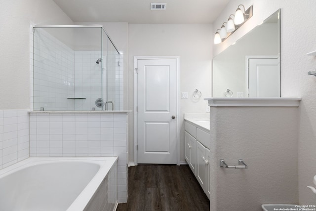 bathroom with vanity, wood-type flooring, and shower with separate bathtub