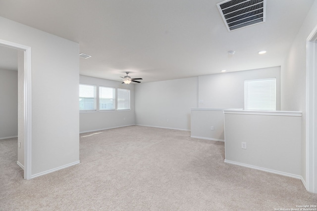 carpeted spare room with ceiling fan