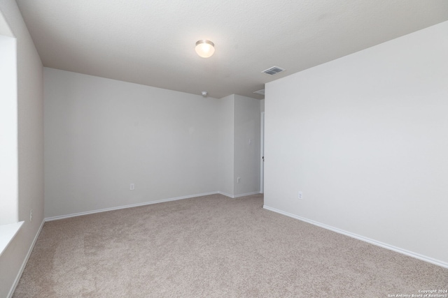 empty room with light colored carpet