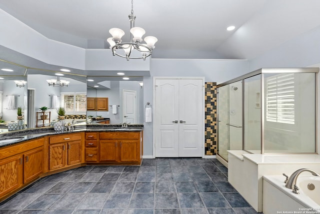 bathroom featuring shower with separate bathtub, vanity, lofted ceiling, and a notable chandelier